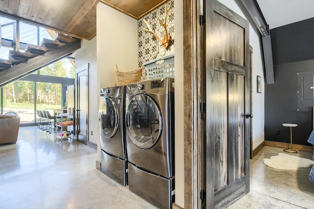 washroom featuring wood ceiling, washer and dryer, and a towering ceiling