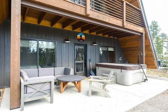 view of terrace featuring outdoor lounge area and a hot tub