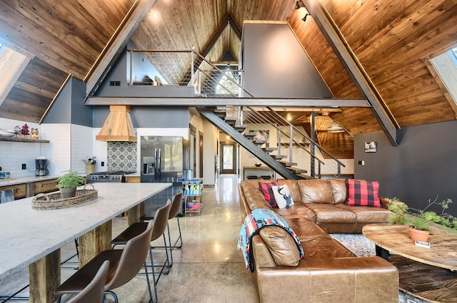 living room with high vaulted ceiling, wood ceiling, and a skylight