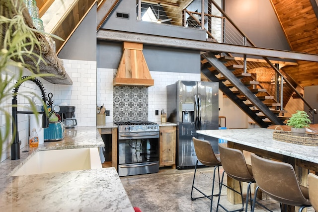 kitchen with backsplash, sink, premium range hood, stainless steel appliances, and light stone counters