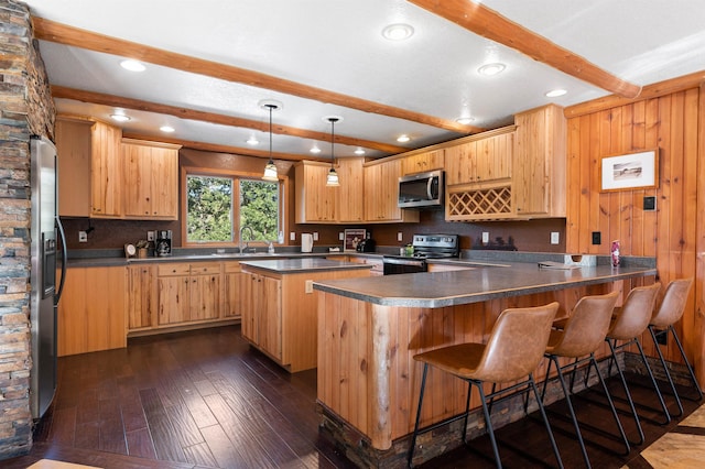 kitchen featuring pendant lighting, sink, dark hardwood / wood-style flooring, stainless steel appliances, and beam ceiling