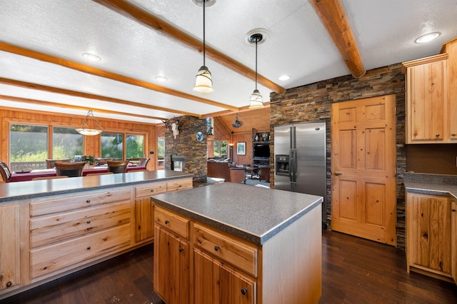 kitchen featuring a center island, beam ceiling, dark wood-type flooring, and stainless steel refrigerator with ice dispenser