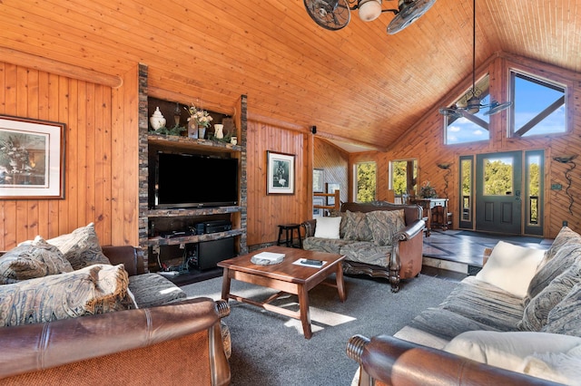 living room with ceiling fan, wooden ceiling, wood walls, dark carpet, and high vaulted ceiling