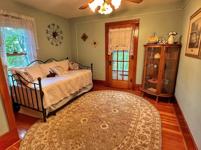 bedroom with dark hardwood / wood-style floors and ceiling fan