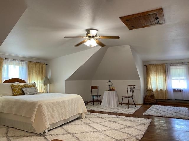 bedroom with lofted ceiling, ceiling fan, and hardwood / wood-style flooring