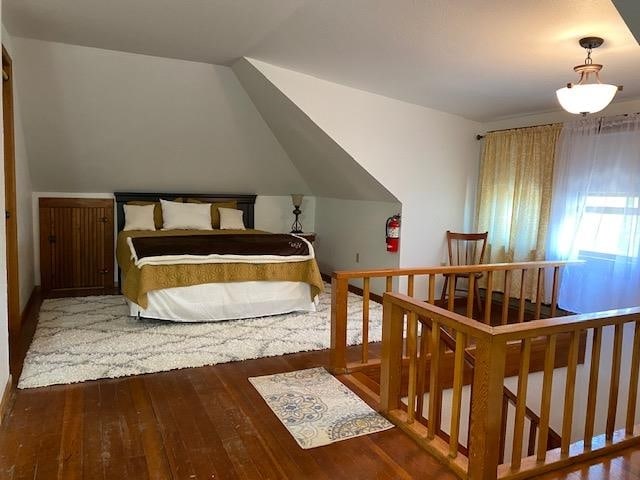 bedroom featuring lofted ceiling and dark hardwood / wood-style floors