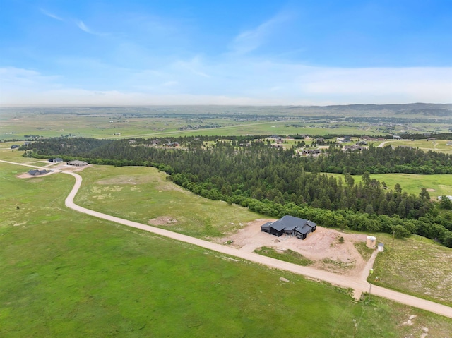 drone / aerial view featuring a forest view and a rural view