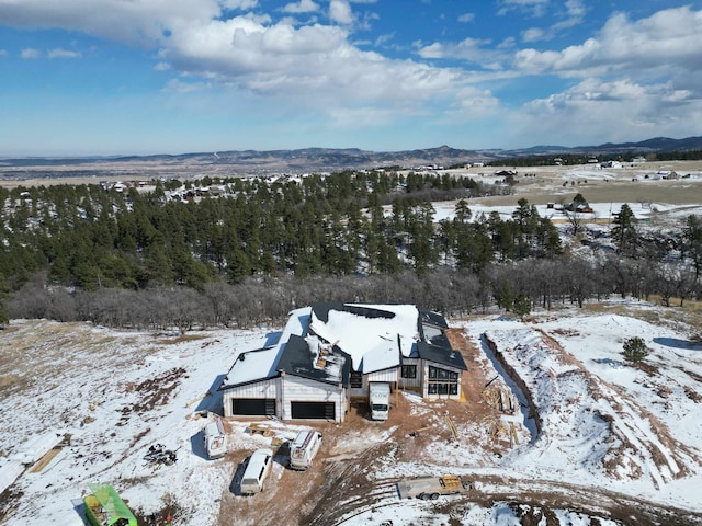 snowy aerial view featuring a mountain view