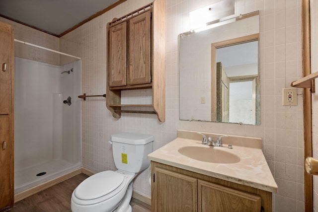 bathroom with tile walls, toilet, vanity, and walk in shower