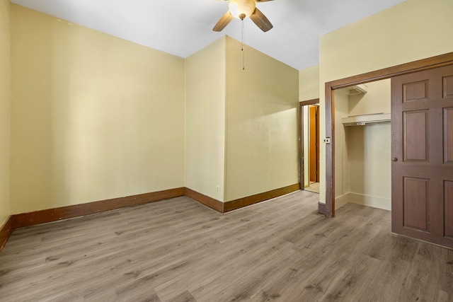 unfurnished bedroom with hardwood / wood-style flooring, ceiling fan, and a closet