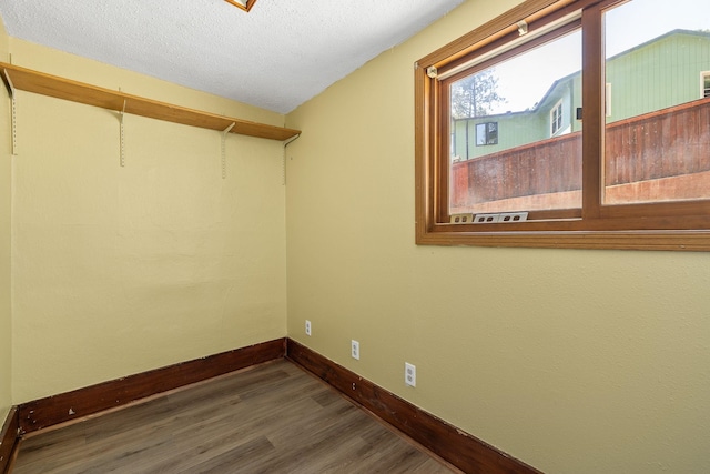 interior space featuring dark hardwood / wood-style flooring and a textured ceiling