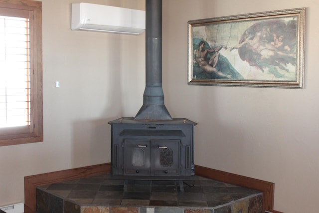 interior details featuring a baseboard radiator, a wall mounted air conditioner, and a wood stove