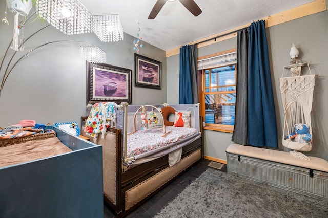 bedroom featuring ceiling fan with notable chandelier