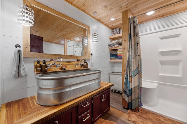 bathroom featuring vanity, wood ceiling, and hardwood / wood-style flooring