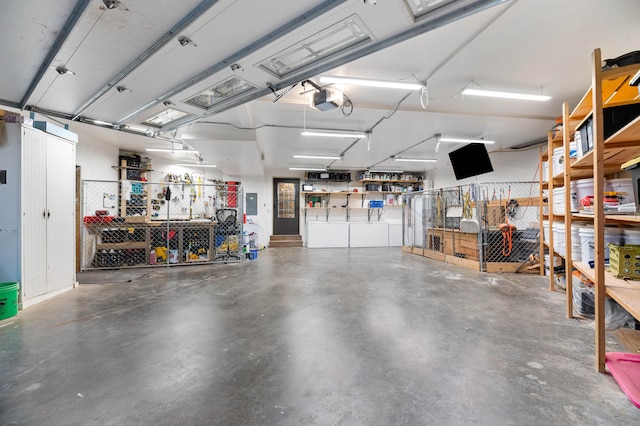 garage featuring a garage door opener and a workshop area