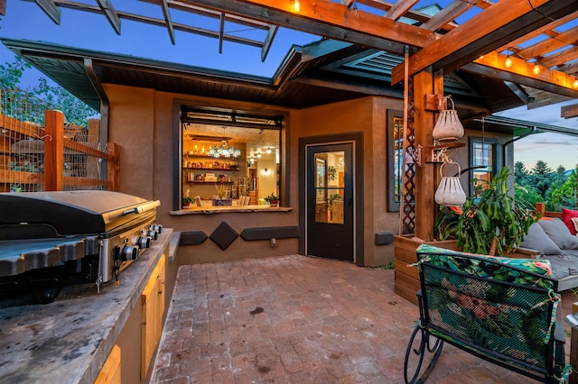 entrance to property with a pergola and a patio