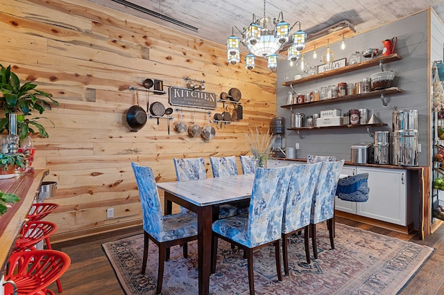 dining room featuring wooden walls, a notable chandelier, dark hardwood / wood-style floors, and wooden ceiling