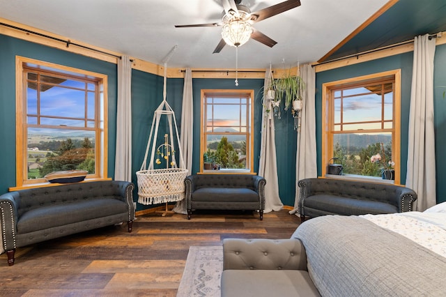 bedroom with dark hardwood / wood-style flooring and ceiling fan