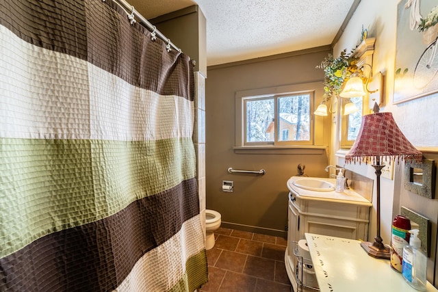 bathroom with a textured ceiling, toilet, vanity, and tile floors