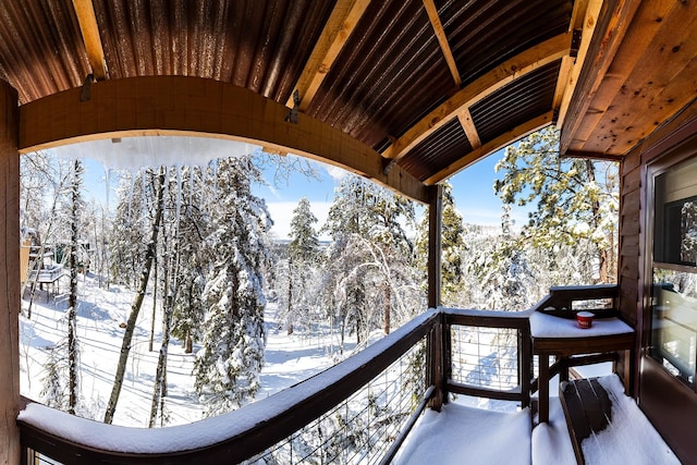 view of snow covered back of property