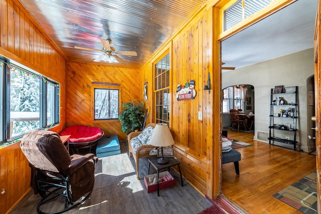 interior space featuring dark hardwood / wood-style floors and wood walls