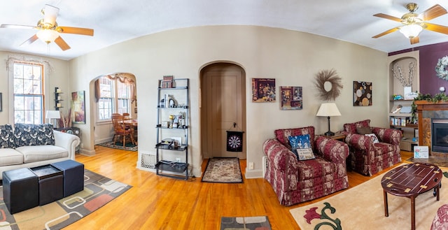 living room featuring ceiling fan and light hardwood / wood-style flooring