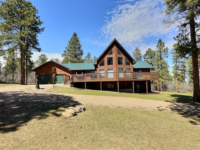 rear view of house with a yard and a wooden deck