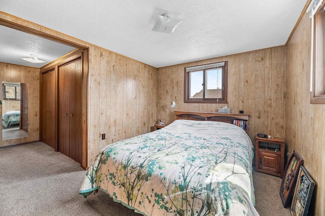 carpeted bedroom with wooden walls and a textured ceiling