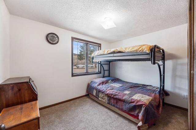 bedroom with a textured ceiling and carpet floors