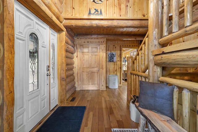 foyer with rustic walls, wooden ceiling, and hardwood / wood-style flooring