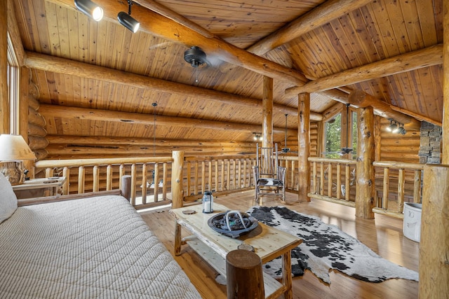 interior space with wood ceiling, light hardwood / wood-style flooring, rustic walls, and vaulted ceiling with beams