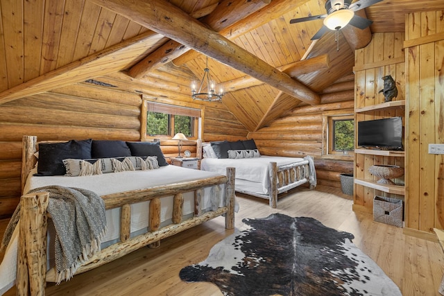 bedroom featuring beamed ceiling, rustic walls, light hardwood / wood-style floors, ceiling fan with notable chandelier, and high vaulted ceiling