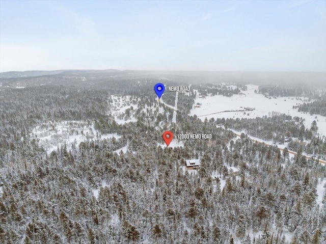 snowy aerial view featuring a mountain view