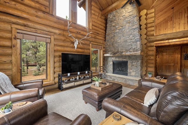 living room with log walls, high vaulted ceiling, hardwood / wood-style floors, and a stone fireplace