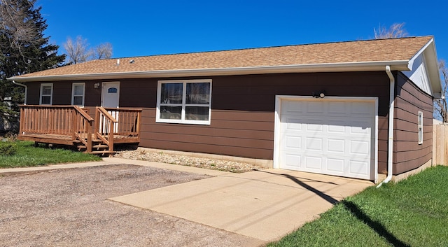 ranch-style home with a wooden deck and a garage