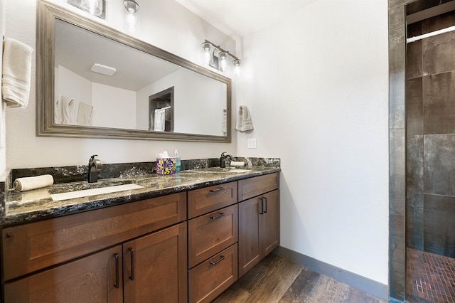 bathroom featuring hardwood / wood-style floors, dual sinks, and oversized vanity