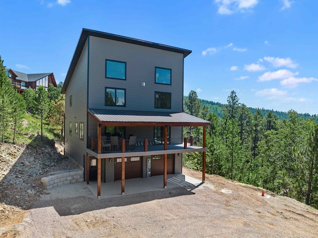 back of house with a patio area and a balcony