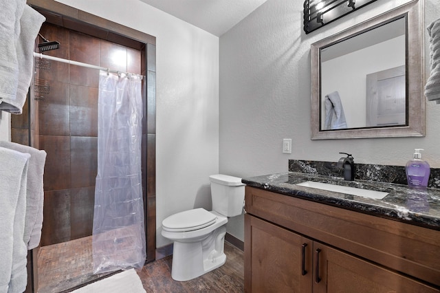 bathroom with curtained shower, hardwood / wood-style flooring, vanity, and toilet