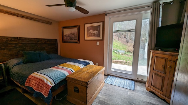 bedroom featuring hardwood / wood-style flooring, multiple windows, ceiling fan, and access to outside