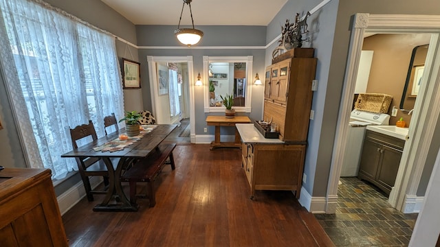 interior space with dark wood-type flooring and washer / clothes dryer