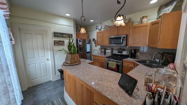 kitchen with dark tile floors, sink, backsplash, hanging light fixtures, and stainless steel appliances