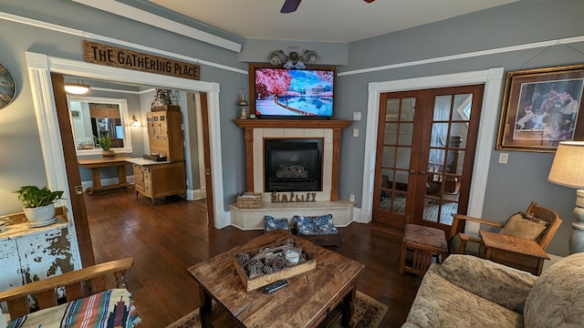 living room with ceiling fan, french doors, and dark hardwood / wood-style flooring