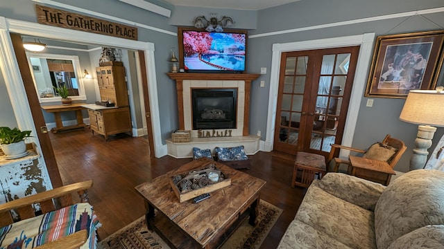 living room featuring french doors, dark hardwood / wood-style floors, and a tiled fireplace