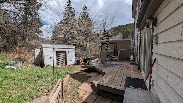 wooden deck featuring a storage unit