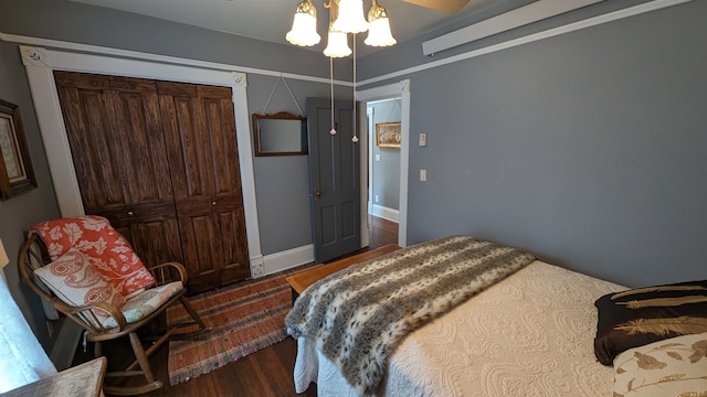 bedroom featuring a closet, ceiling fan, and dark wood-type flooring