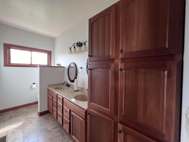 bathroom with tile flooring and double sink vanity