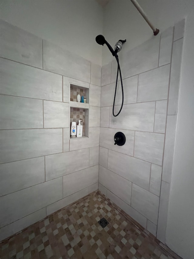 bathroom with tiled shower