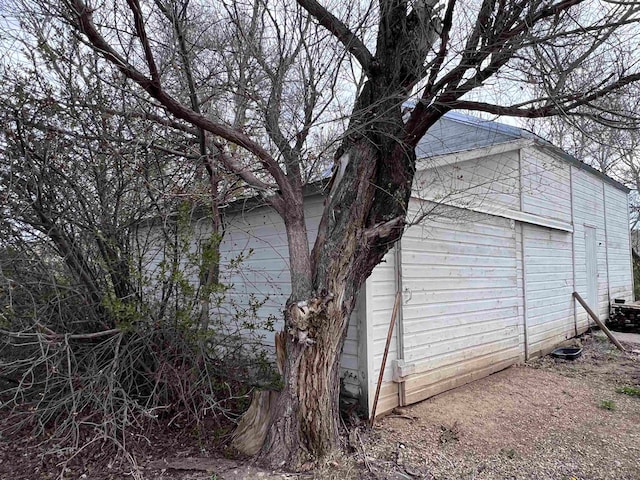 view of home's exterior featuring an outdoor structure and a garage