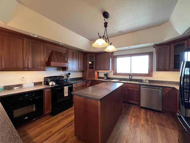 kitchen featuring dark hardwood / wood-style floors, premium range hood, black appliances, and a tray ceiling