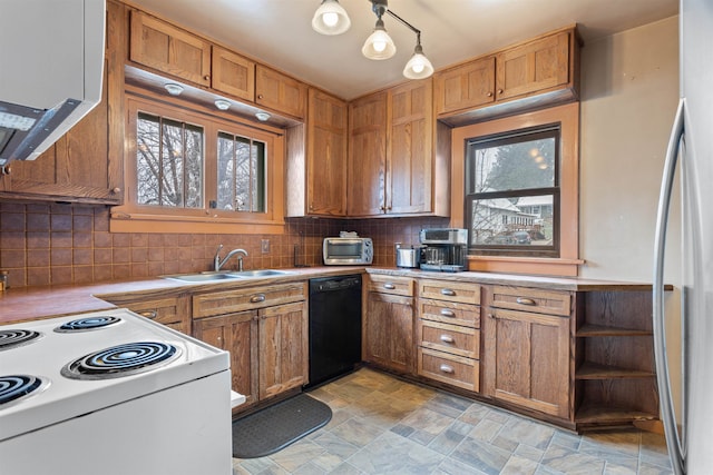 kitchen with light tile floors, sink, dishwasher, tasteful backsplash, and stainless steel fridge